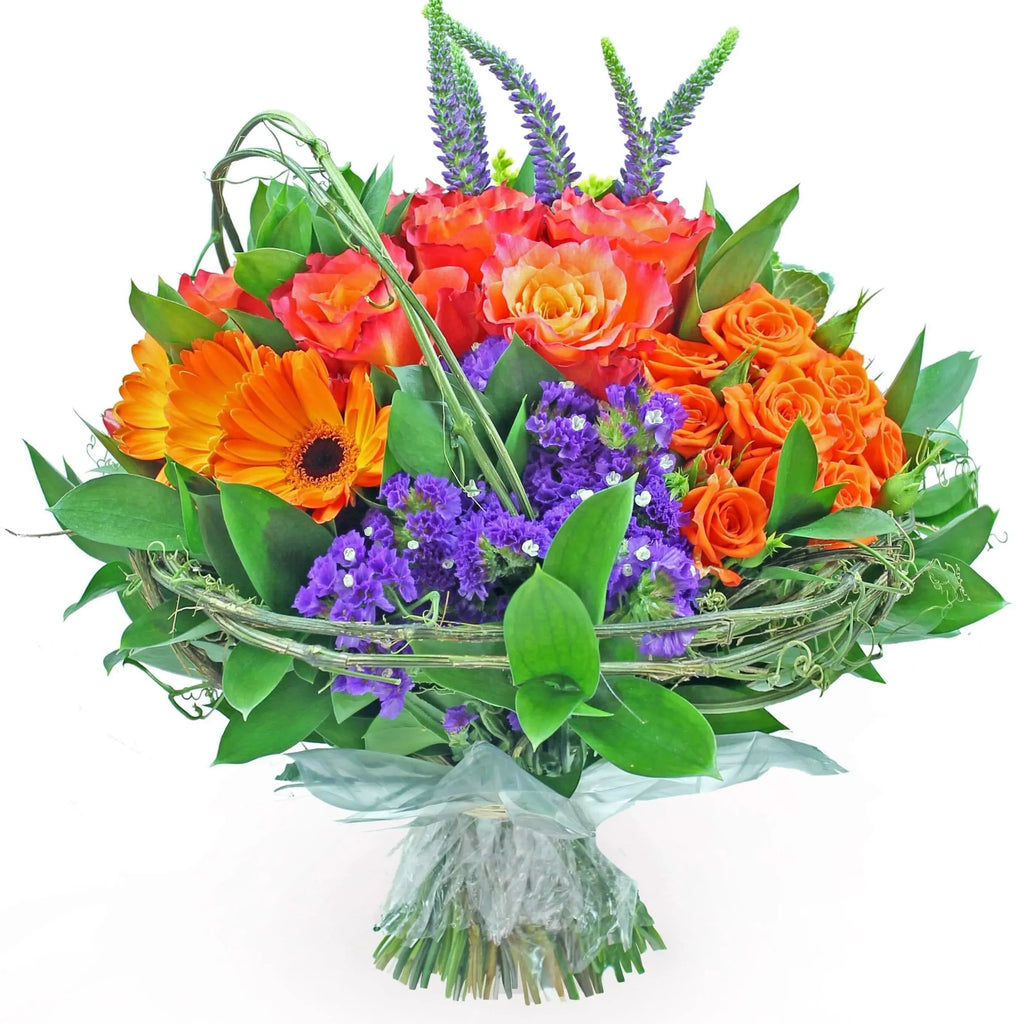 Mixed luxury bouquet in warm tones with gerberas, sinensis, roses, spray roses, veronicas, kale, achillea, hypericum and ruscus.
