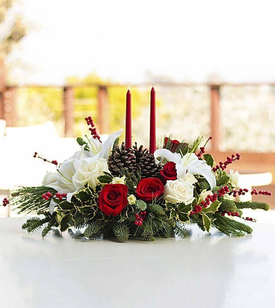 Christmas Wishes Centerpiece - red roses , white roses , noble fir , white pine , variegated holly , red candles, red berries , pinecones , centrepiece