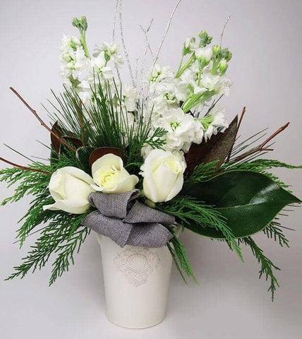 Classic White -made with fresh cedar, crisp white roses and stocks and accented with magnolia leaves and branches. white stocks, magnolia leaves, white roses, cedar, evergreens. 