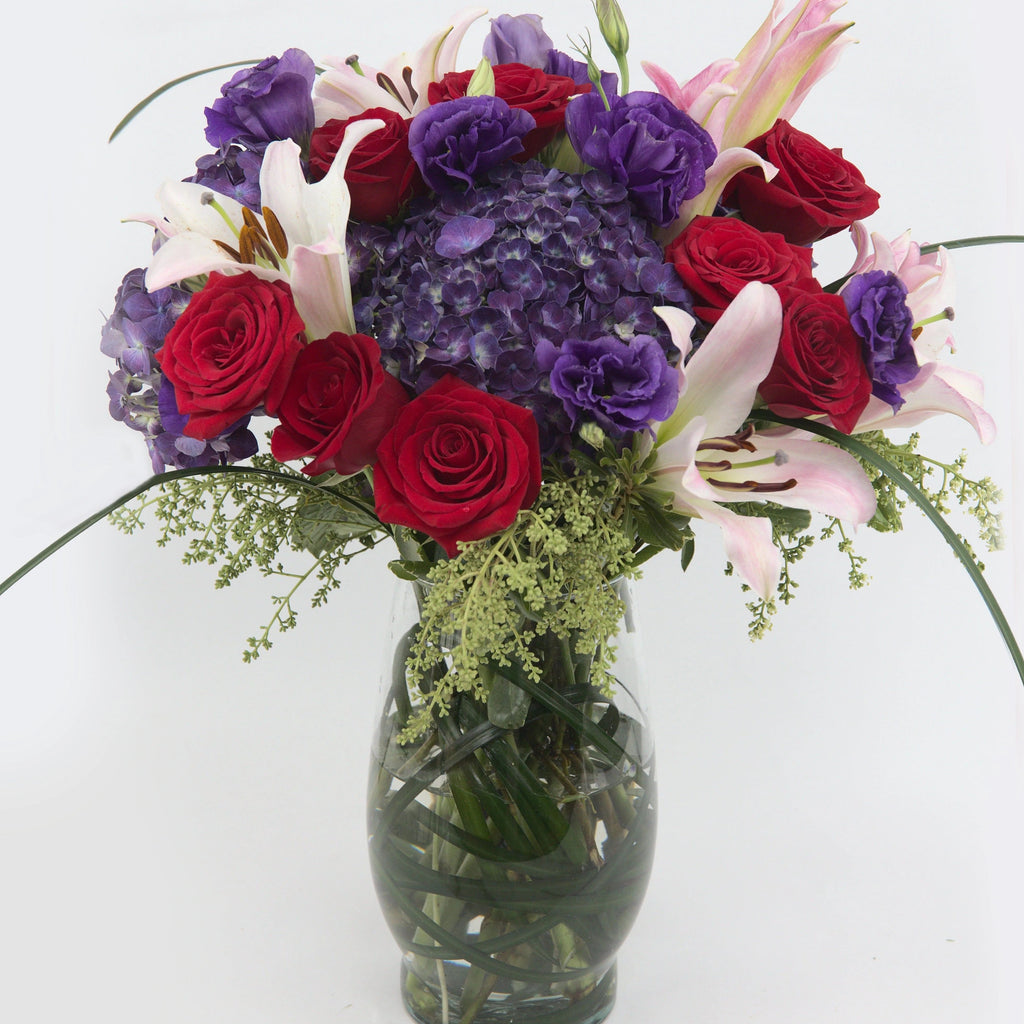 Love Shine Luxury Bouquet - vase of purple hydrangea, purple double lisianthus, red roses, pink roses, pink Asiatic Lilies, and lush greens
