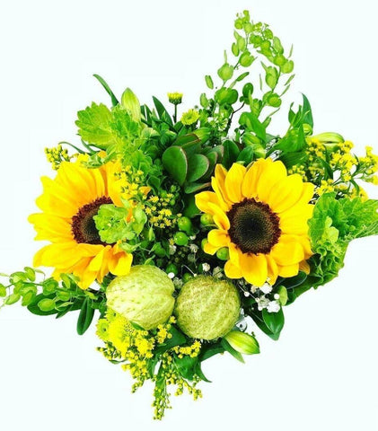 Mixed bouquet for St. Patrick's Day including sunflowers, bells of ireland, moby dick, hypericum, solidago, ruscus, echeveria and pennycress.