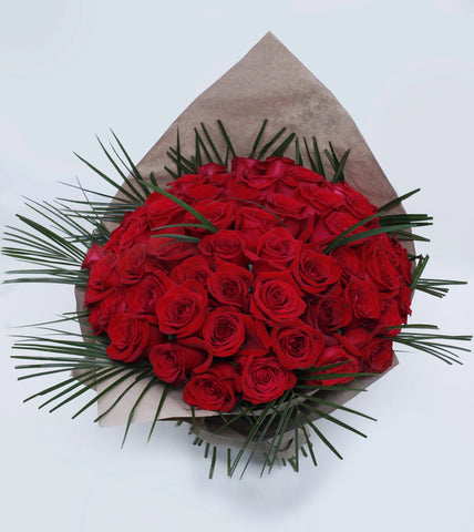 Unforgettable 50 Rose Hand-tied - red roses , palm leaves , steel grass, bouquet